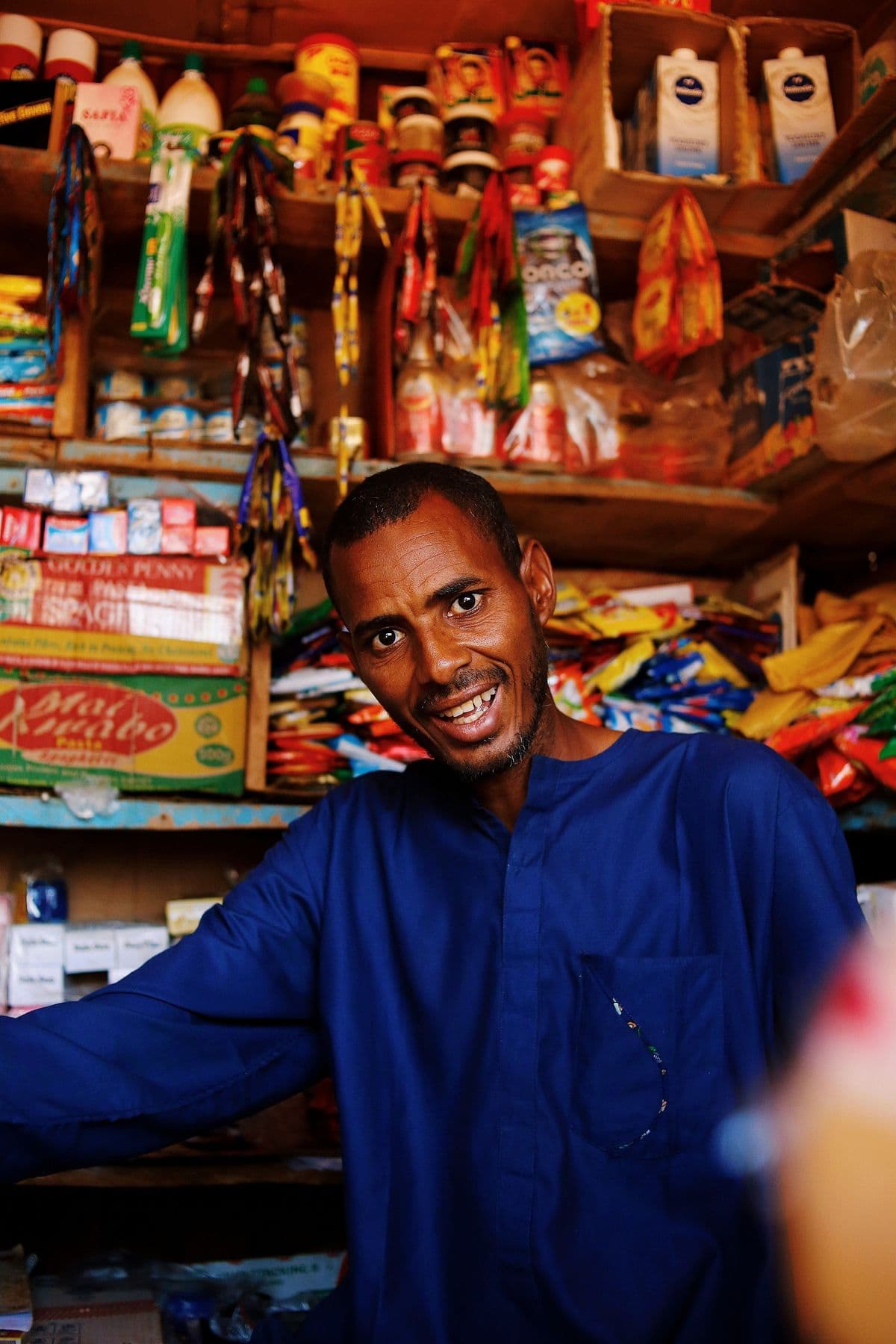 A shop owner checking stock on a tablet