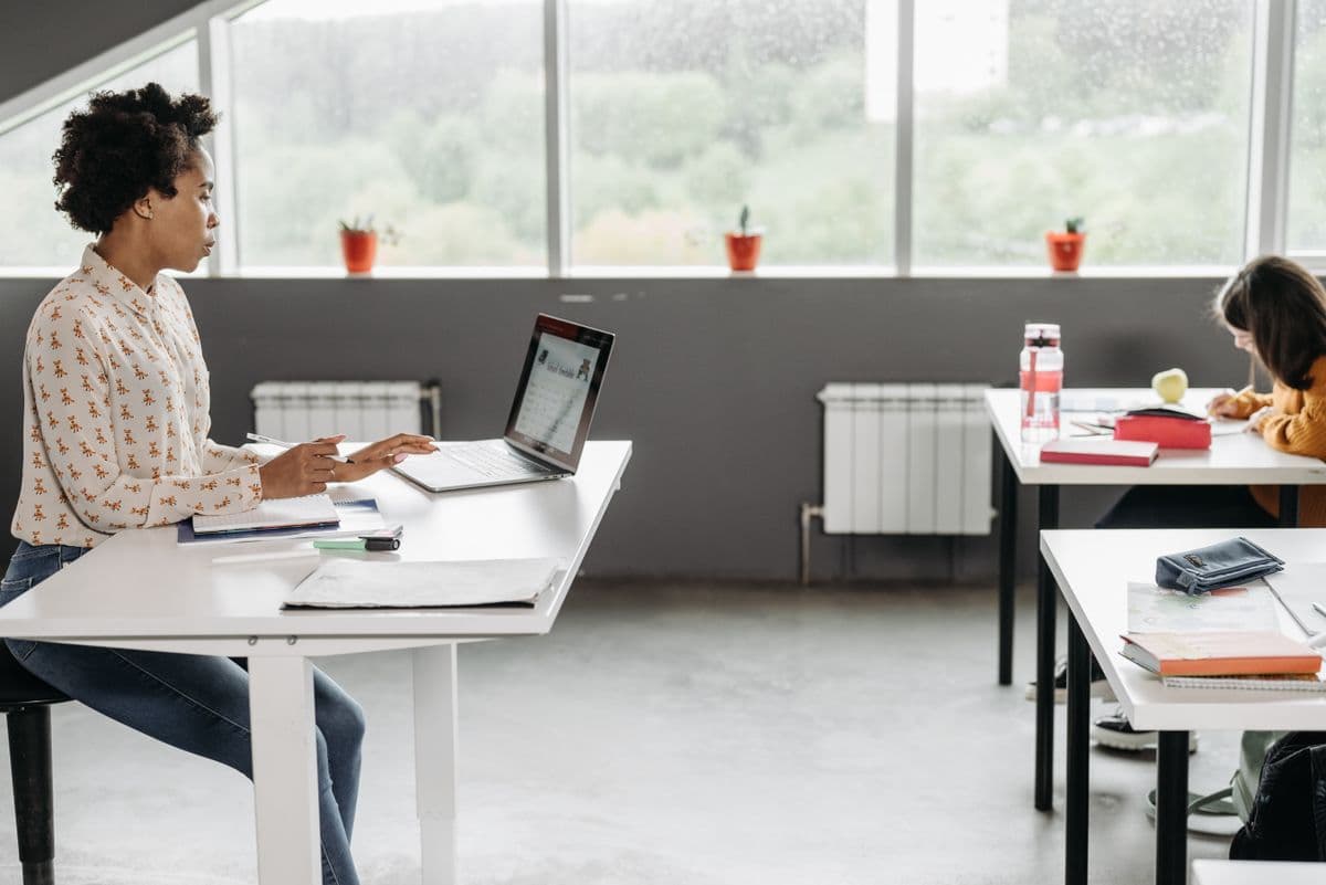 A school administrator reviewing student records on a laptop