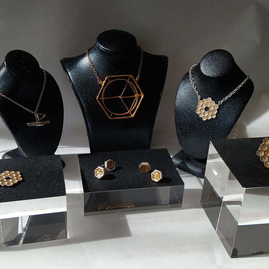 Cast metal jewellery pieces displayed on stands